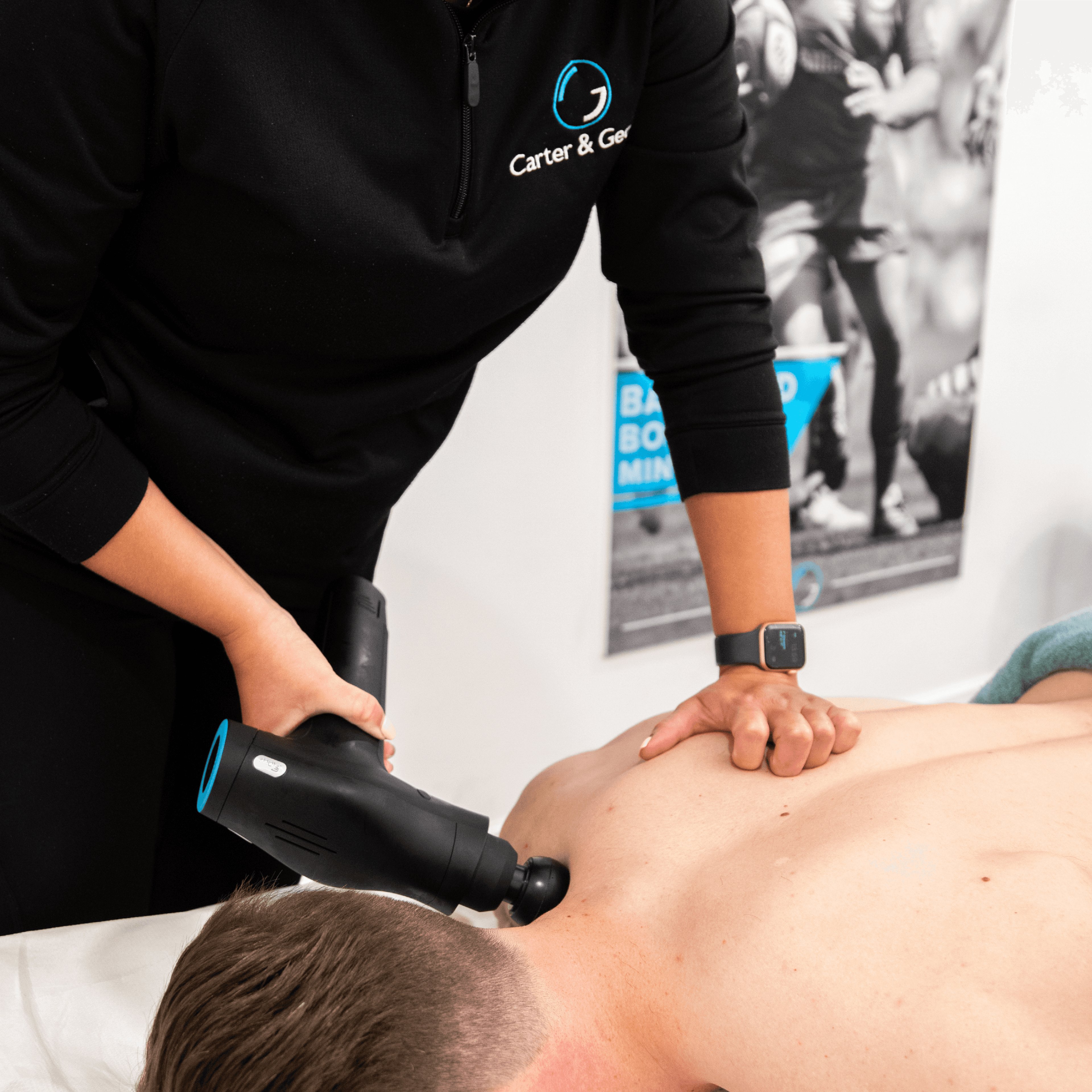 A physiotherapist treats shoulder pain at Carter & George in Hertford, offering hands-on care in a modern, professional clinic.